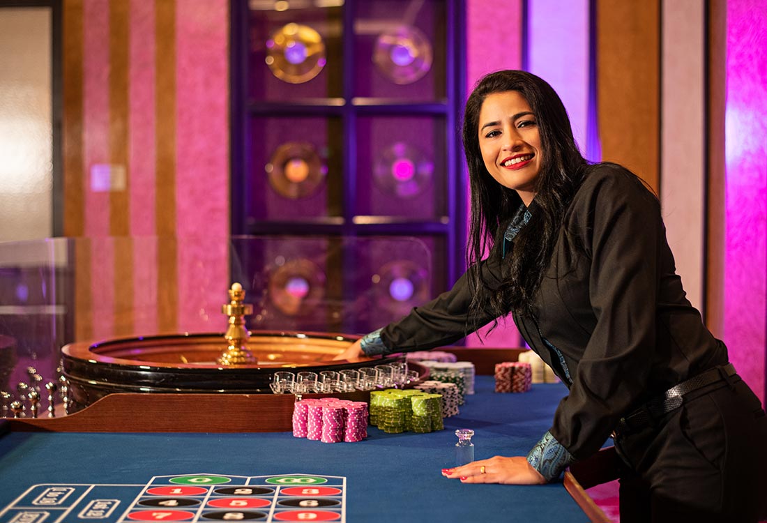 Woman spinning the wheel for Roulette at the Casino